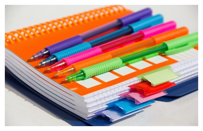 Stack of colored notebooks.